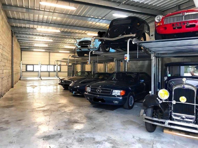 garage with parking doubler system with cars parked on two levels